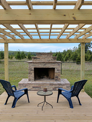 DIY Outdoor Fireplace under pergola